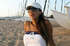 Cute tanned asian french babe in white talks on the beach