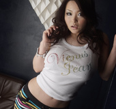 Mind-blowing brunette wearing black top, metallic hat and denim shorts