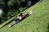 Cute interracial couple enjoys the warm sunshine in the park and moves