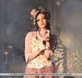 High heeled beauty in stockings and pink dress getting nude on the chair