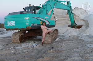 Foxy babe displays her smoking hot body before she takes off her white bra and releases her monster boobs before she pulls down her jeans shorts and blue panty and expose her luscious pussy in different poses wearing her brown boots outdoor by a backhoe. - XXXonXXX - Pic 12