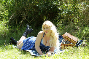 Blonde hottie strips off her blue and white polka dotted dress and displays her foxy body in blue underwear and black boots before she takes off her bra and shows her juicy boobs then strips down her panty and reveals her indulging pussy in a grass field. - XXXonXXX - Pic 1