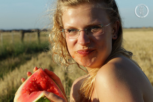 Blonde babe with glasses teases with her foxy body while she eats her watermelon in a crop field before she stips off her white dress and shows her lusty pussy and sweet crack in different poses in a crop field. - XXXonXXX - Pic 15