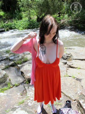Foxy chick with steaming hot body shows her juicy tits before she strips off her orange dress and blue shoes before she gets naked and expose her sweet crack as she spreads wide by the river. - Picture 8