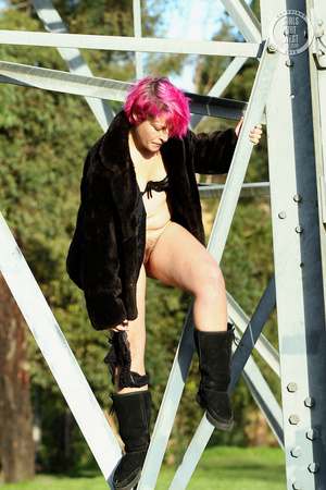 Pink haired chick display her foxy body outdoor wearing her black lingerie, coat and boots then shows her juicy boobs before she pulls down her black panty and reveals her indulging pussy. - Picture 7
