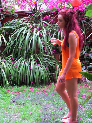 Pink haired chick peels off her orange dress and displays her smoking hot body in blue bikini before she takes off her bra and reveals her small tits in different poses in the garden. - Picture 7