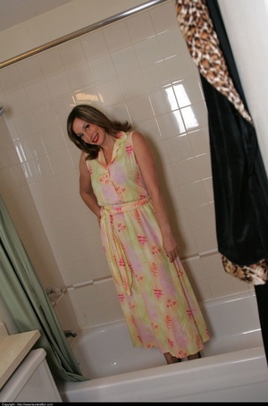 Floral dress brunette posing naked in a full bath tub - XXXonXXX - Pic 1