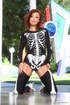 Skeleton get-up redhead slowly undressing outdoors