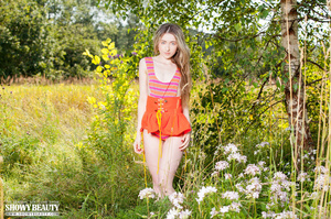 Alluring babe in orange and pink leotard and orange skirt displays her indulging body in a flower field before she gets naked and bares her tiny tits and lusty pussy in different poses. - XXXonXXX - Pic 3