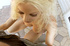 Blonde babe with a pink bow gets on her knees to suck