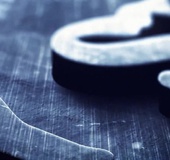 Corset-wearing brunette with wavy hair fucked on a couch