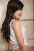 Wet white top brunette gets naked in the bathroom
