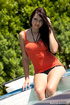 Orange top and black lingerie brunette gets into a hot tub