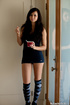 Tight brunette in knee-length socks gets naked