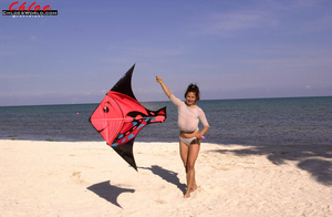 Tanned and busty brunette loves kites an - Picture 2