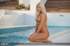 Banging blonde displays her foxy body wearing her sexy bikini by the pool