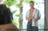 Luscious ebony lays down on a gray bed and teases a handsome dude with