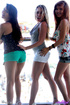 Three teens in short shorts flash their asses on the balcony