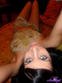 Blue-eyed teen in a belly dancer get-up naked on a bed