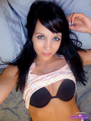 Tight white pants brunette shows her pussy on a bed - Picture 6