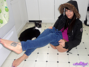 Winter jacked brunette takes off her clothes on the floor - Picture 7