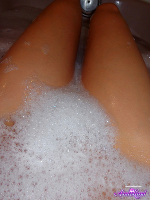 Wet brunette with blue eyes scrubbing her body in a bathtub - XXXonXXX - Pic 2