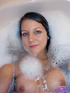 Brunette with firm tits taking a hot bubble bath