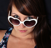 Heart-shaped shades brunette fucks her pussy with a pink toy