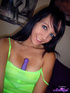 Tight green tank-top brunette uses a fancy purple vibrator