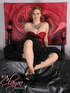 Sophisticated redhead wearing red and black dress with diamond jewelry