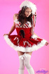 Naughty brunette wearing sexy santa outfit with white stockings shows