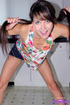 Playful brunette with pigtails wearing two piece colorful stripped string