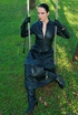 Black haired mistress in leather coat and black boots flashing her yummy