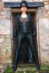 Red lipped brunette in black leather coat and cap exposing her tits under