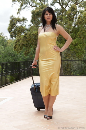 Yellow latex dress brunette posing next to a swimming pool with suitcase - Picture 1