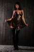 Latex dress and thigh-length boots brunette shows her pussy
