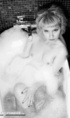 Amazing blonde teases her pussy in the bubble bath.