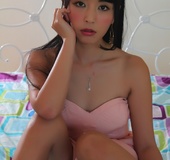 Innocent Asian brunette with bangs covering her nipples