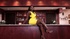 Ebony gal in yellow dress and shiny bikini strips on the bar stand before