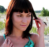 Small tits babe with black hair posing outdoors in green top before undressing