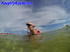 Blonde exhibitionist lays on the red floating bed in the ocean while nude