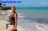 Blonde milf exhhibitionist sits by concrete wall during a warm day wearing