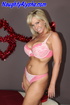 Cute blonde momma wearing sexy pink and white laced two piece bikini sits