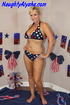 Patriotic blonde whore wearing red, white, and blue star bikini sits on