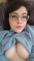 glasses-wearing brunette shows her
