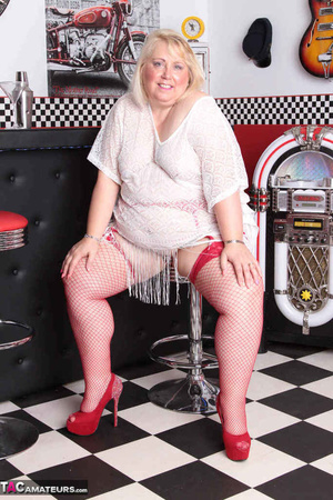 High heeled bbw in red stockings taking off white dress and posing naked by the bar stand - XXXonXXX - Pic 1