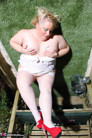Pierced pussy bbw in red heels and white stockings riding huge dildo on the bench outdoors - Picture 13