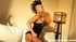 Extremely hot tattooed brunette poses on the sofa