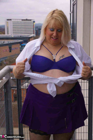 High heeled bbw in black stockings and purple miniskirt sheds blue bra and exposing her pierced snatch on the balcony - XXXonXXX - Pic 7