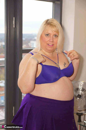 High heeled bbw in black stockings and purple miniskirt sheds blue bra and exposing her pierced snatch on the balcony - Picture 17